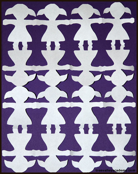 A step by step tutorial on how to make a paper doll chain with kids.